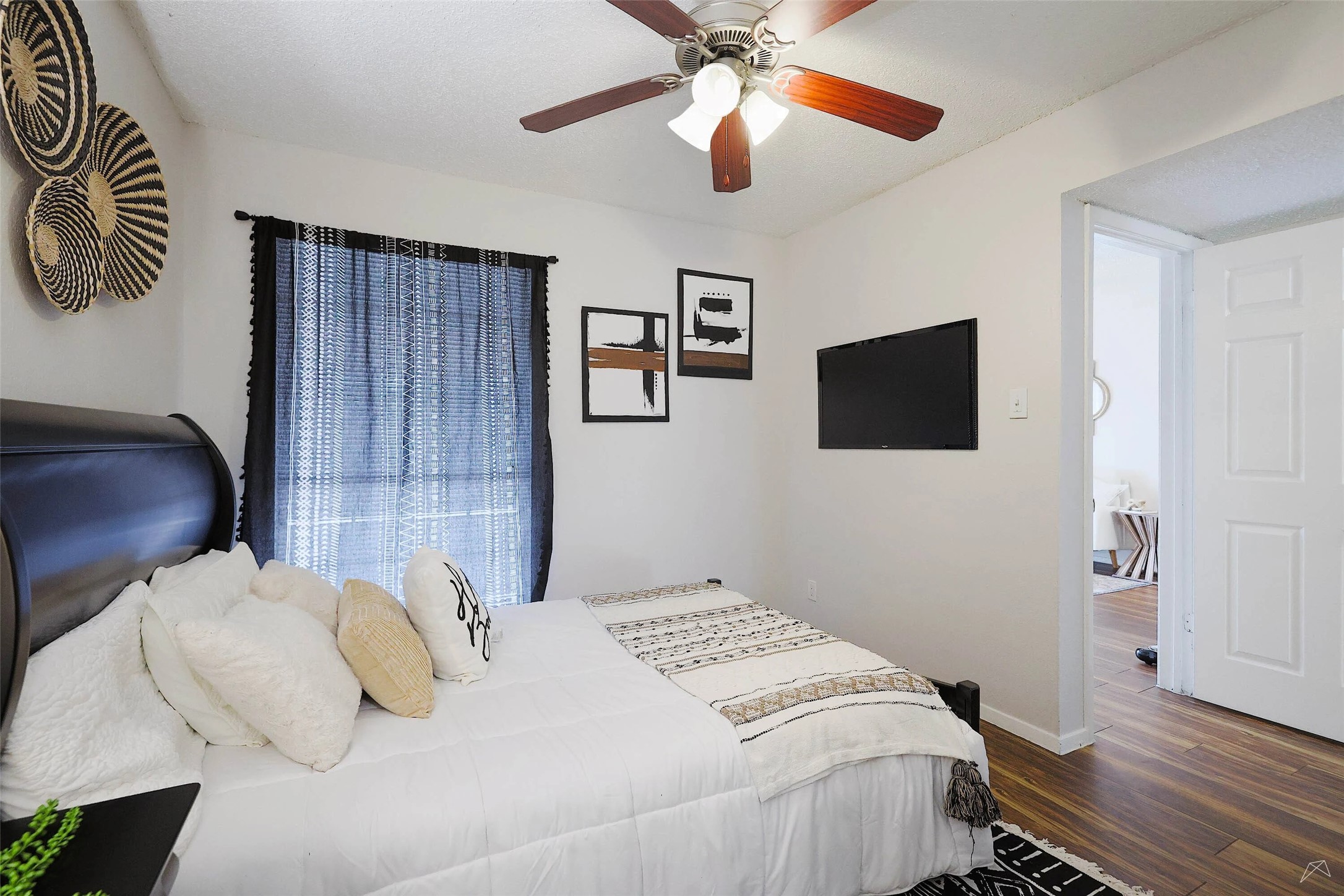 6808 South I-35 Frontage Road, Unit 111 Austin, TX 78745 - Photo 6 of 22 a bedroom with a bed and a flat screen tv