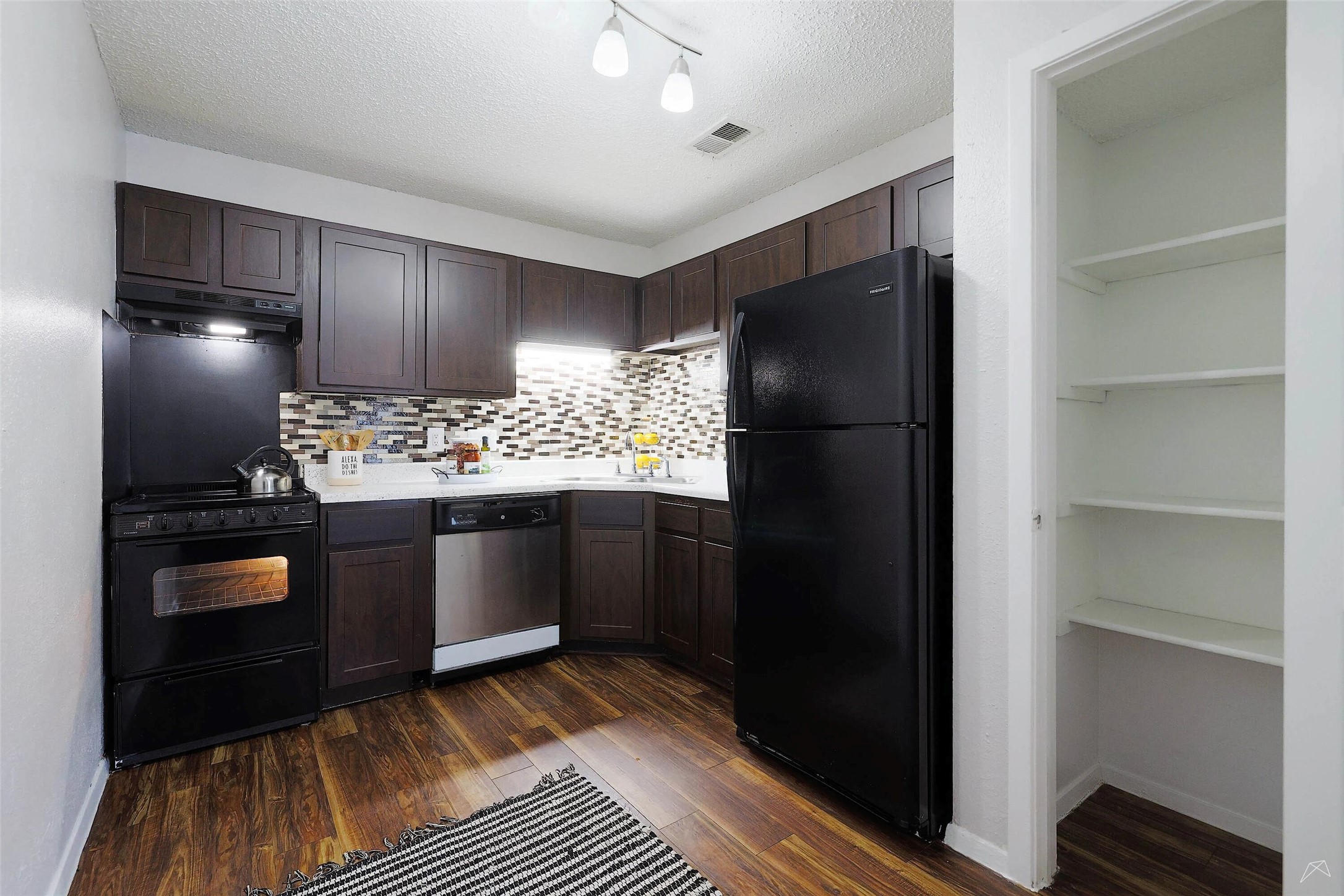6808 South I-35 Frontage Road, Unit 111 Austin, TX 78745 - Photo 8 of 22 a kitchen with a refrigerator and stove