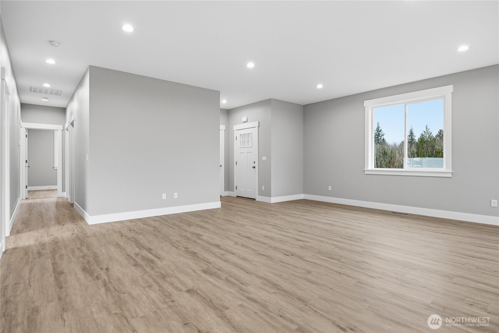 6473 Watson Loop Maple Falls, WA 98266 - Photo 2 of 25 a view of an empty room with wooden floor and windows