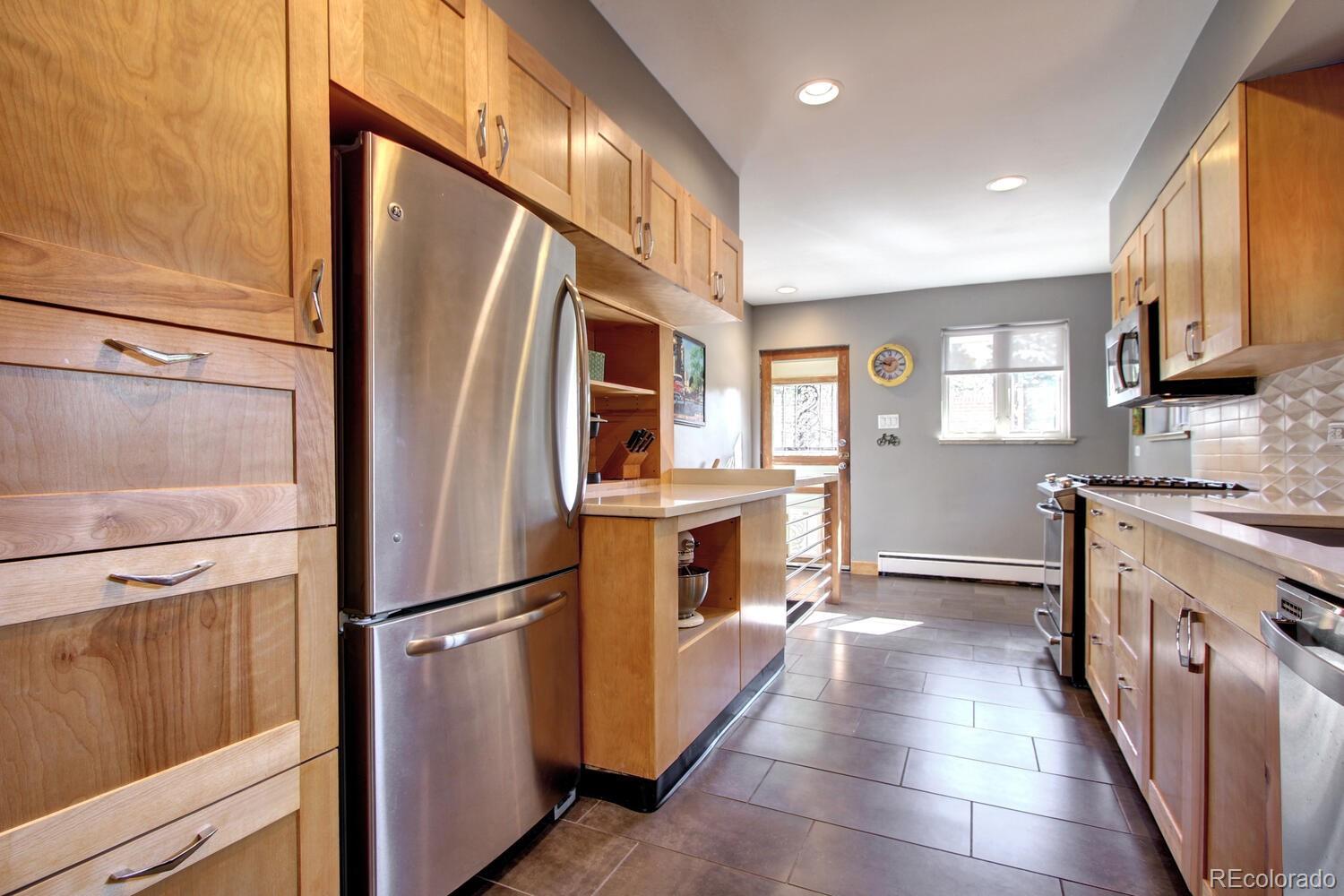 1300 Elm Street Denver, CO 80220 - Photo 12 of 40 a kitchen with stainless steel appliances granite countertop a refrigerator a stove and a sink