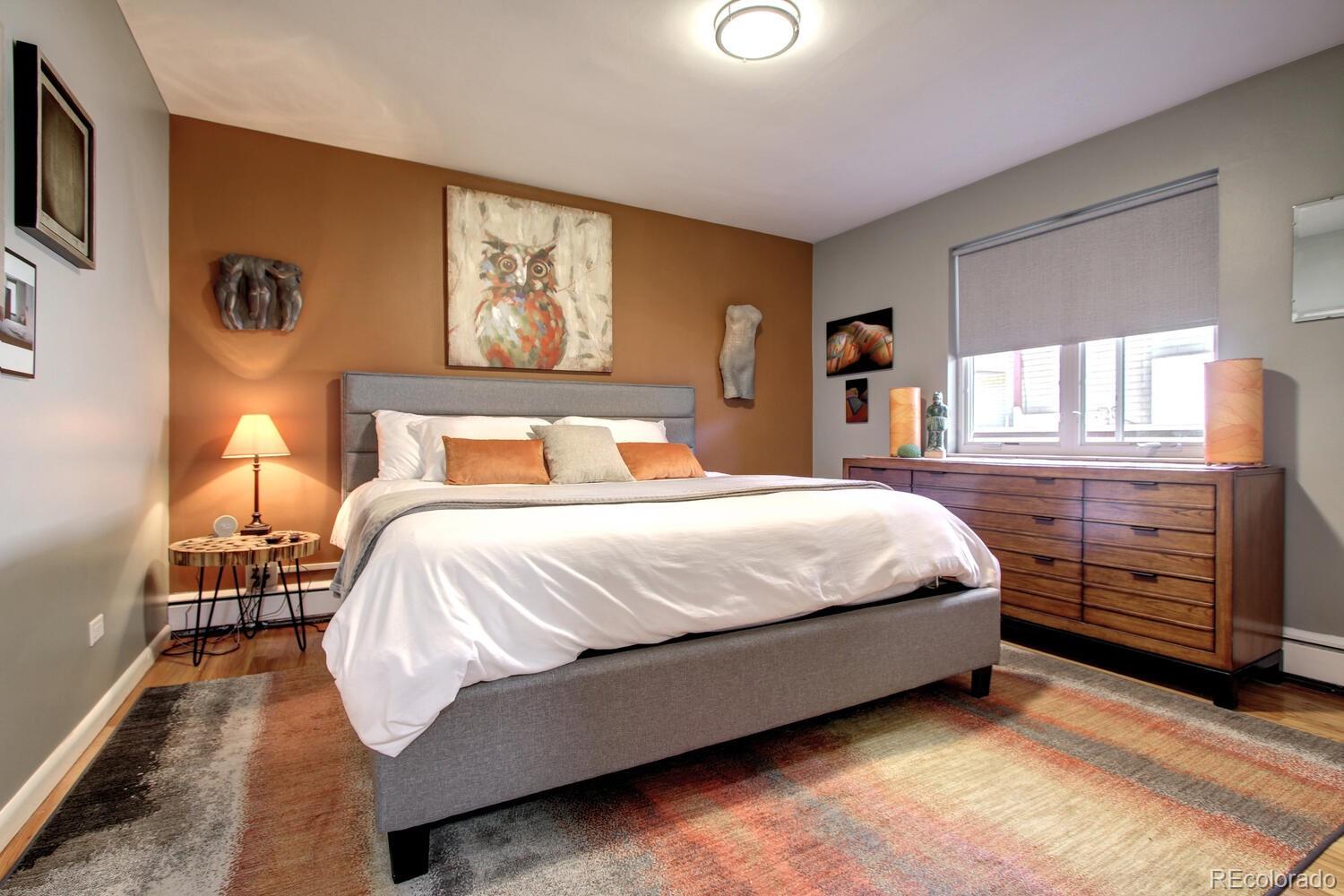 1300 Elm Street Denver, CO 80220 - Photo 17 of 40 a bedroom with a bed and wooden floor