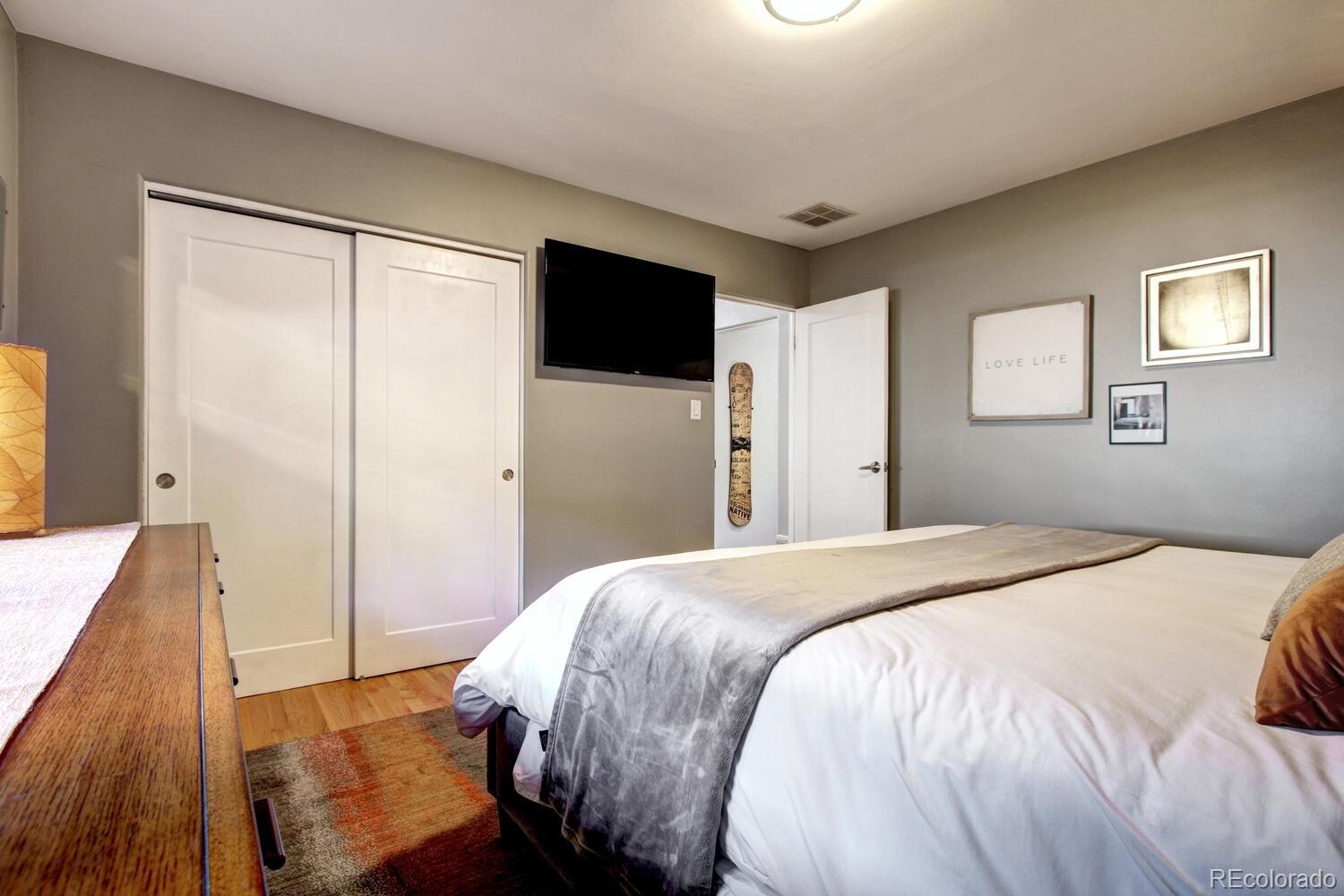 1300 Elm Street Denver, CO 80220 - Photo 18 of 40 a bedroom with a bed and a large mirror