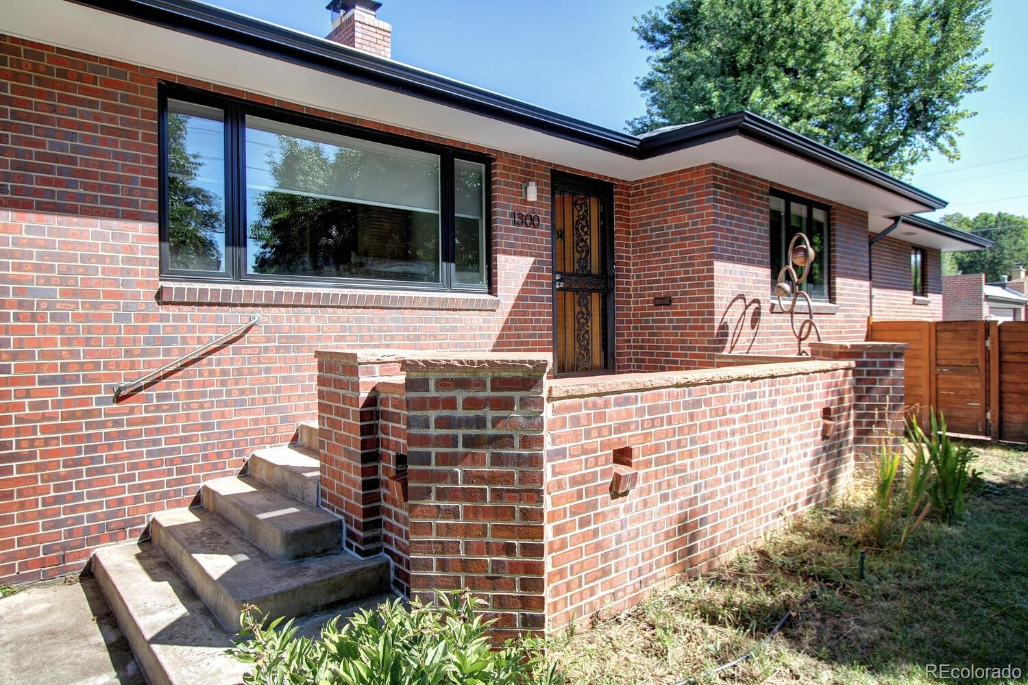1300 Elm Street Denver, CO 80220 - Photo 2 of 40 a front view of a house with glass windows