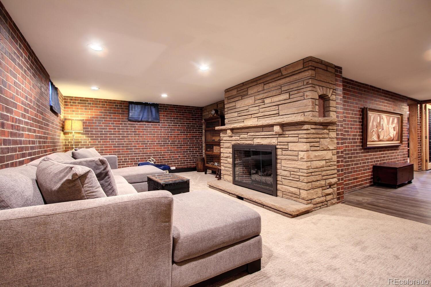 1300 Elm Street Denver, CO 80220 - Photo 25 of 40 a living room with furniture and a fireplace