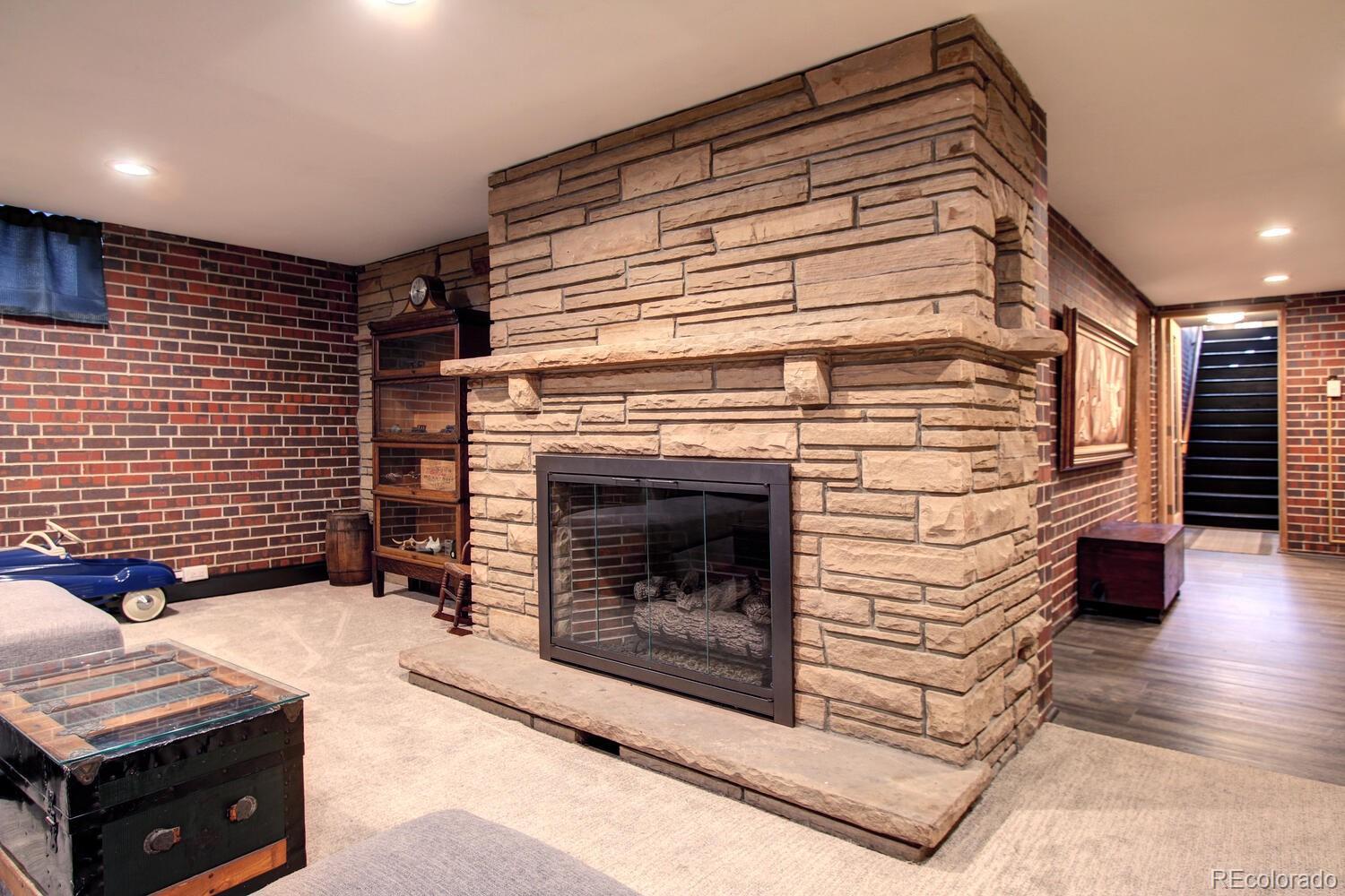 1300 Elm Street Denver, CO 80220 - Photo 26 of 40 a view of an empty room with wooden floor and a fireplace