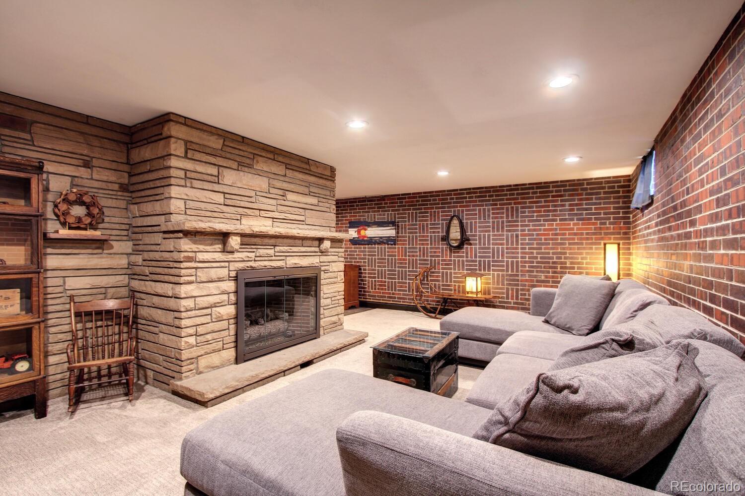 1300 Elm Street Denver, CO 80220 - Photo 27 of 40 a bedroom with furniture and a fireplace