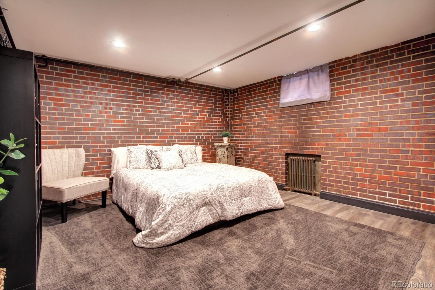 1300 Elm Street Denver, CO 80220 - Photo 28 of 40 a spacious bedroom with a bed and a chair