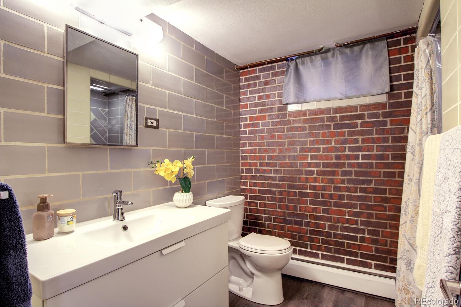 1300 Elm Street Denver, CO 80220 - Photo 30 of 40 a bathroom with a toilet sink and mirror