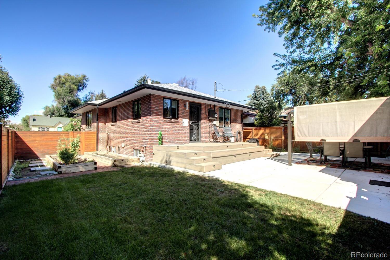 1300 Elm Street Denver, CO 80220 - Photo 34 of 40 a view of a house with a yard