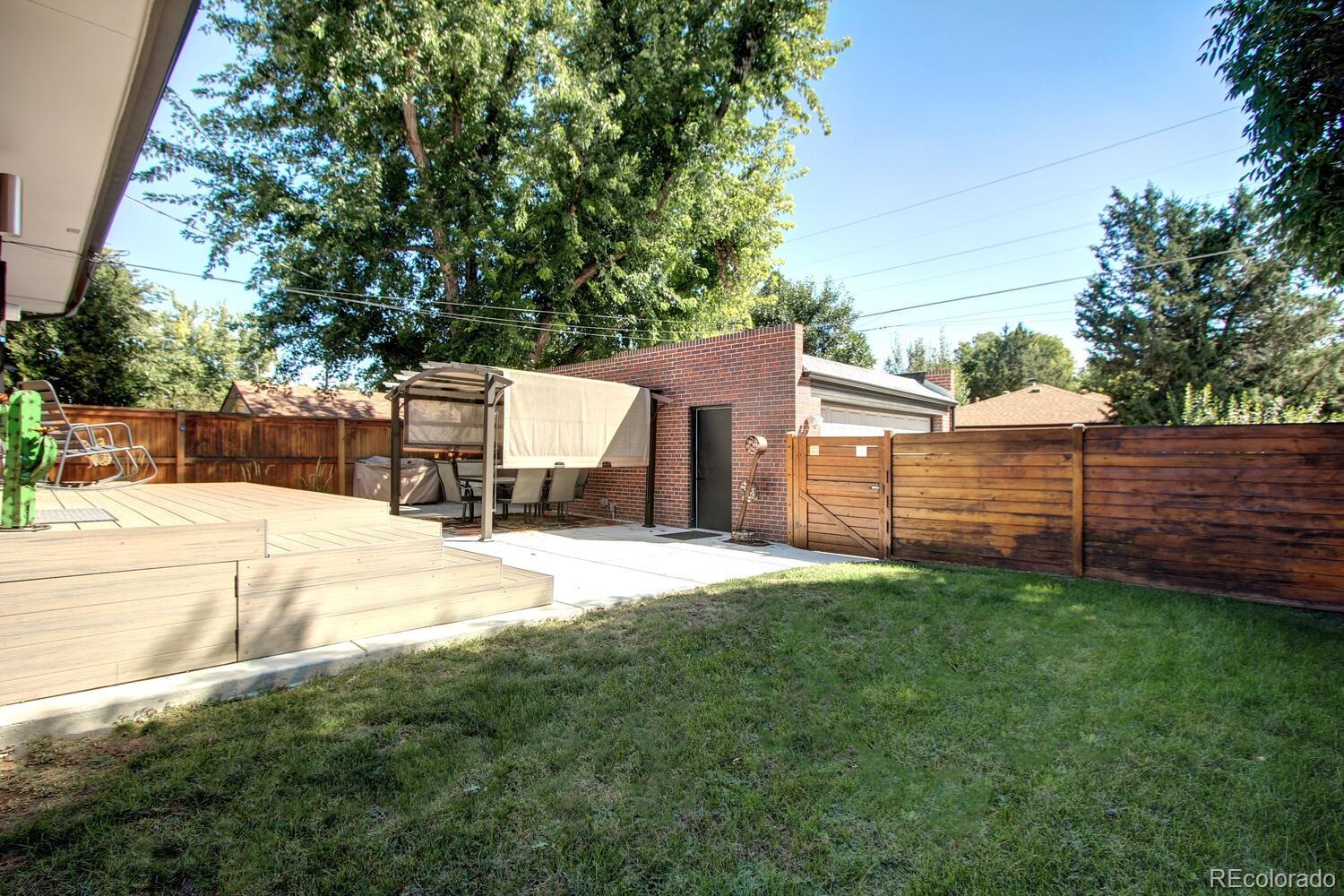 1300 Elm Street Denver, CO 80220 - Photo 36 of 40 a view of a backyard with a small cabin