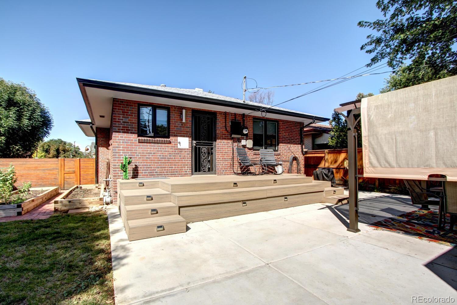 1300 Elm Street Denver, CO 80220 - Photo 37 of 40 a view of a patio with table and chairs a flat tv screen next to yard