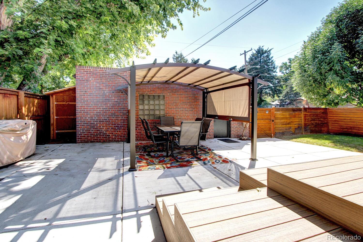 1300 Elm Street Denver, CO 80220 - Photo 39 of 40 a view of a terrace with chairs and iron fence