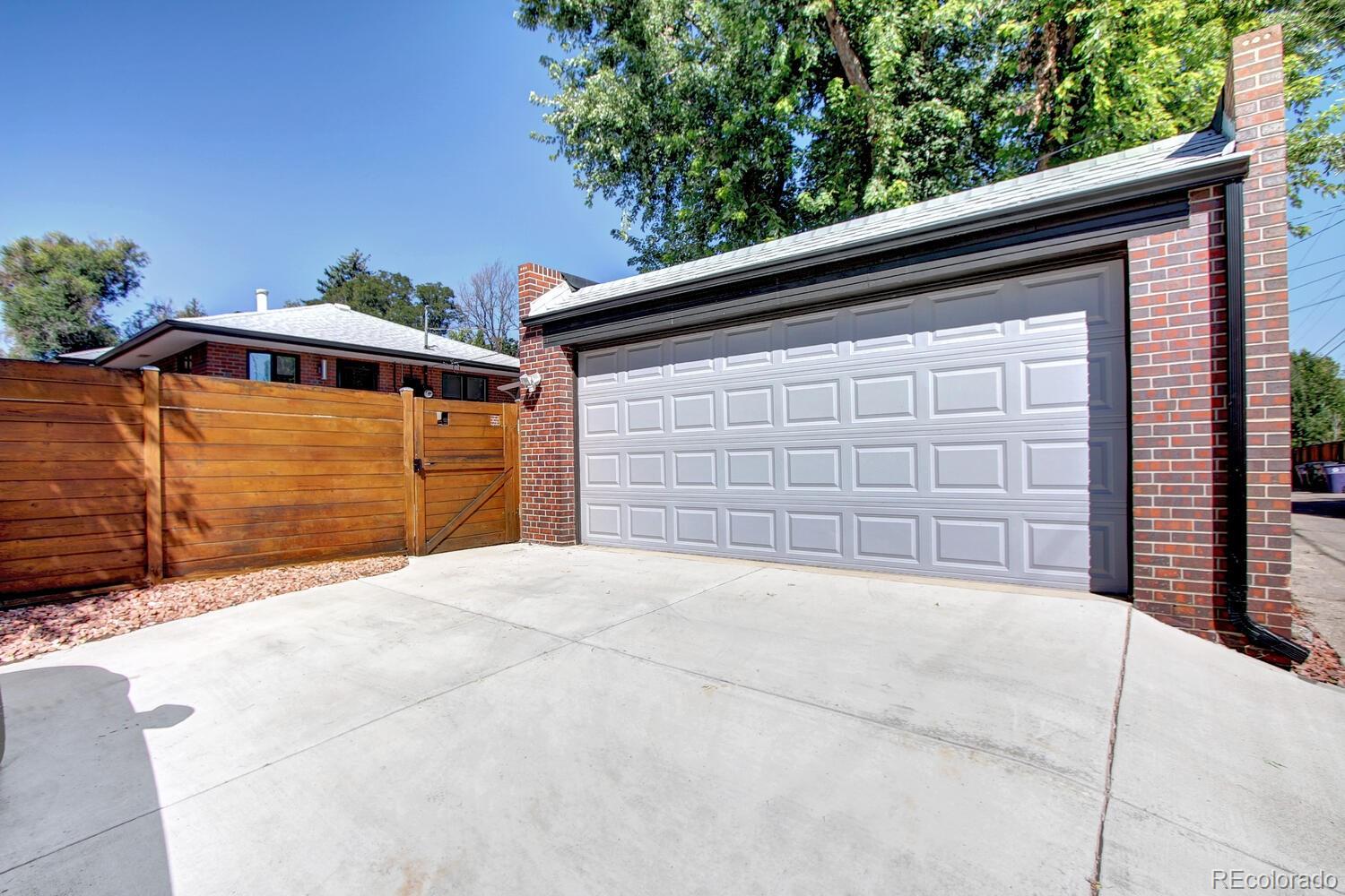 1300 Elm Street Denver, CO 80220 - Photo 40 of 40 a front view of a house with a yard and garage