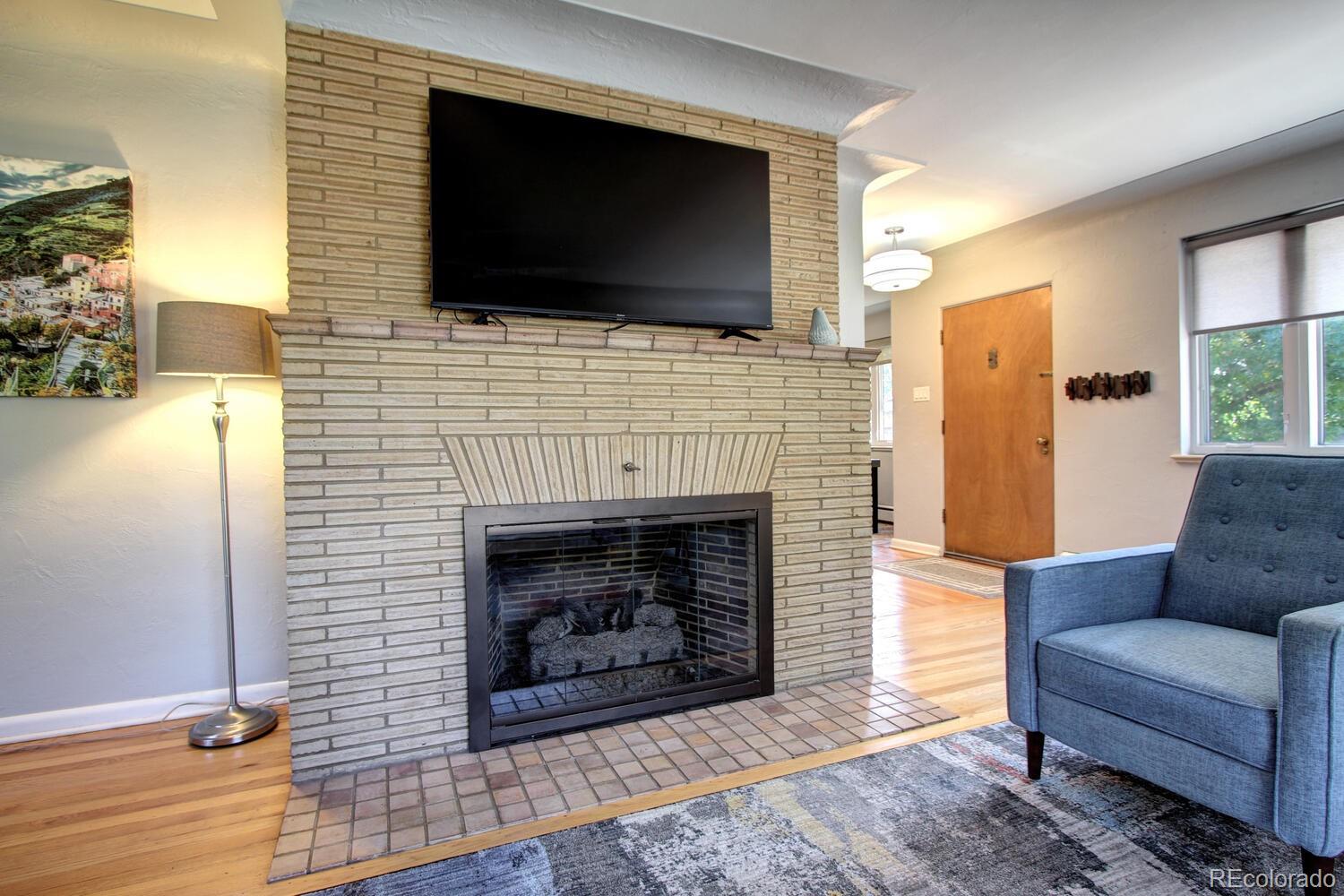 1300 Elm Street Denver, CO 80220 - Photo 7 of 40 a living room with furniture and a fireplace