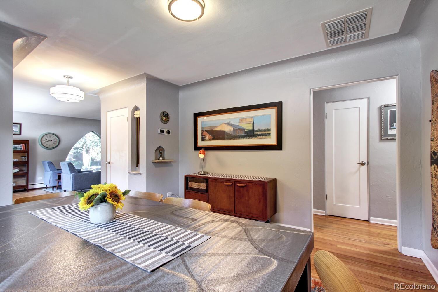 1300 Elm Street Denver, CO 80220 - Photo 10 of 40 a bedroom with a bed and dresser with wooden floor
