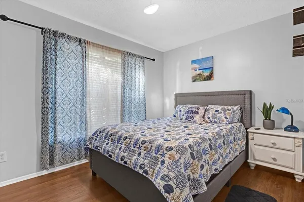 a bedroom with a large bed and a window