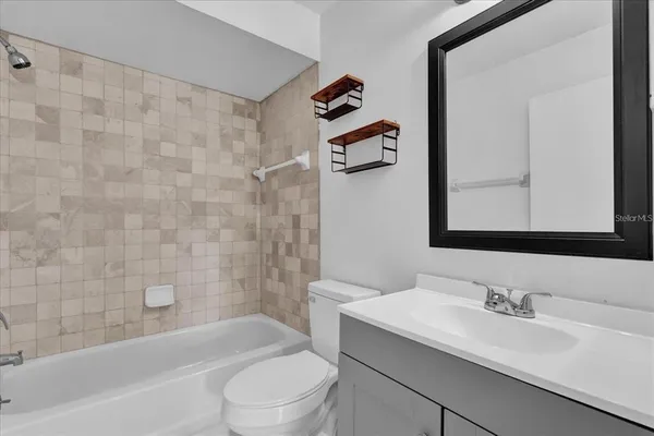 a bathroom with a sink a toilet and a bathtub