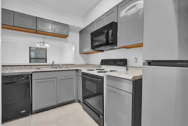 a kitchen with a sink stove and microwave