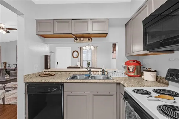 a kitchen with stainless steel appliances granite countertop a sink and a stove