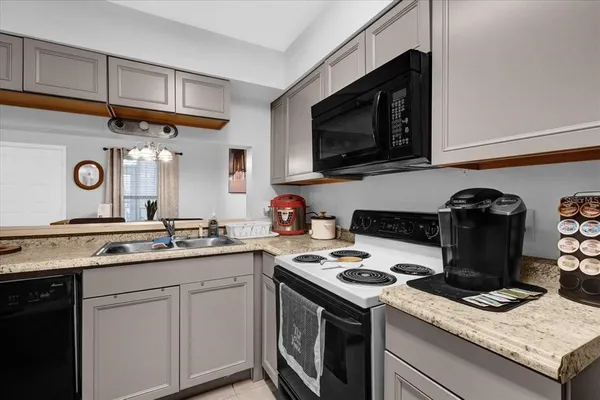 a kitchen with granite countertop cabinets and steel stainless steel appliances