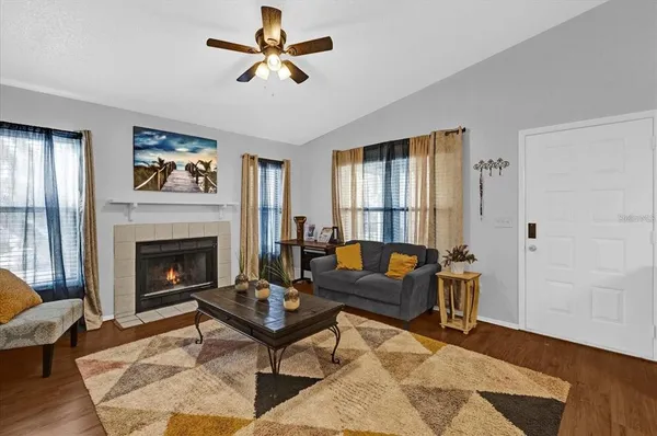 a living room with furniture and a fireplace