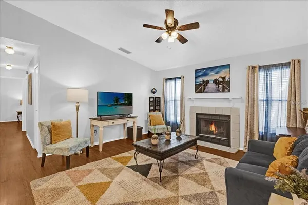 a living room with furniture a rug and a fireplace
