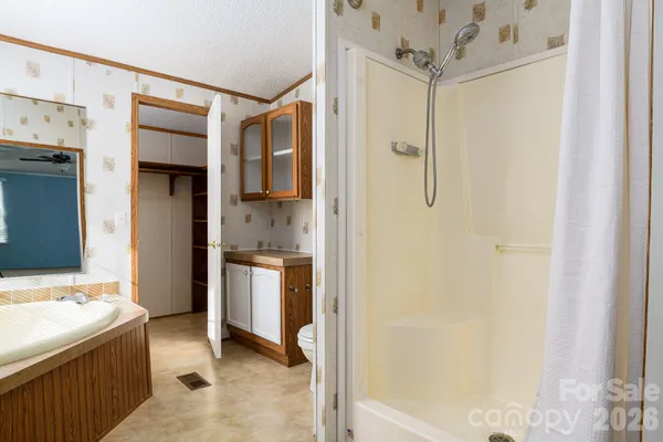 a bathroom with a bathtub and a shower