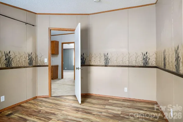 a bathroom with a granite countertop sink a toilet a mirror and shower