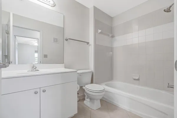 a bathroom with a sink toilet vanity and bathtub