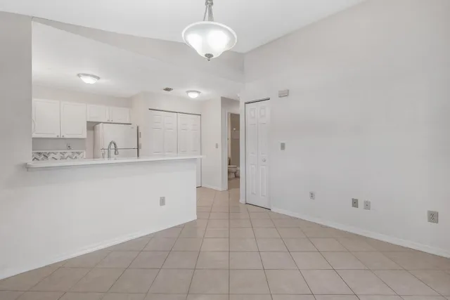 a view of kitchen with center island and stainless steel appliances