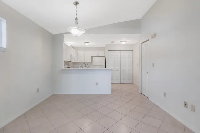 a view of a kitchen with a sink dishwasher and a refrigerator
