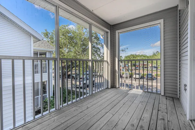a view of balcony with wooden floor