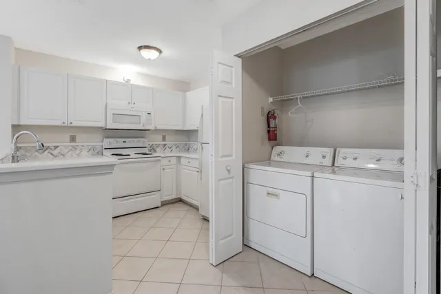 a kitchen with white cabinets stainless steel appliances and sink