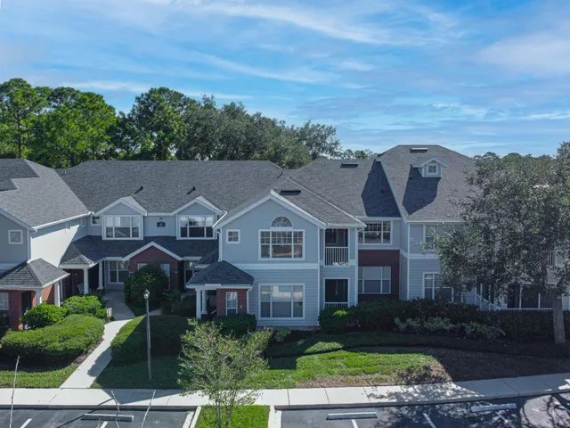 an aerial view of multiple houses with a yard