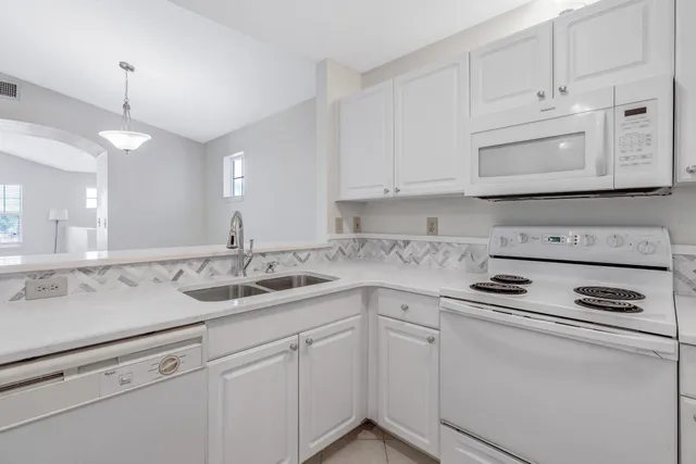 a kitchen with appliances cabinets and a sink