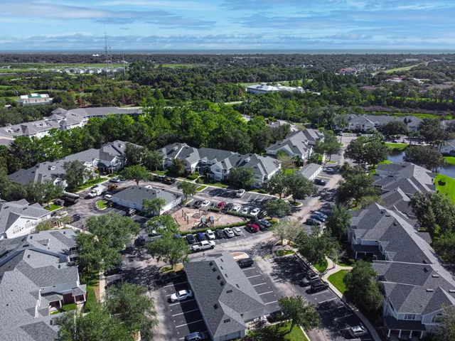 an aerial view of a house with a yard and outdoor seating