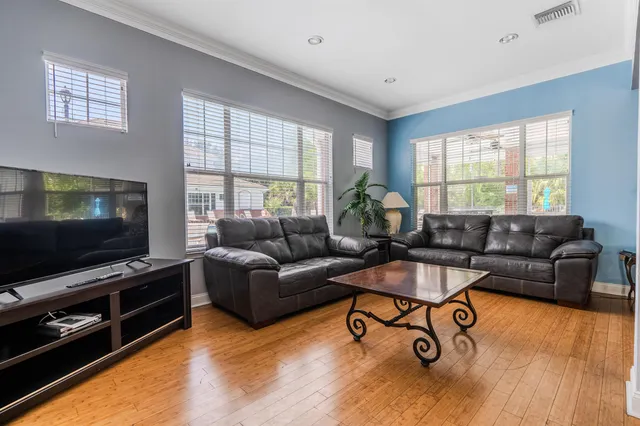a living room with furniture gym equipment and a rug