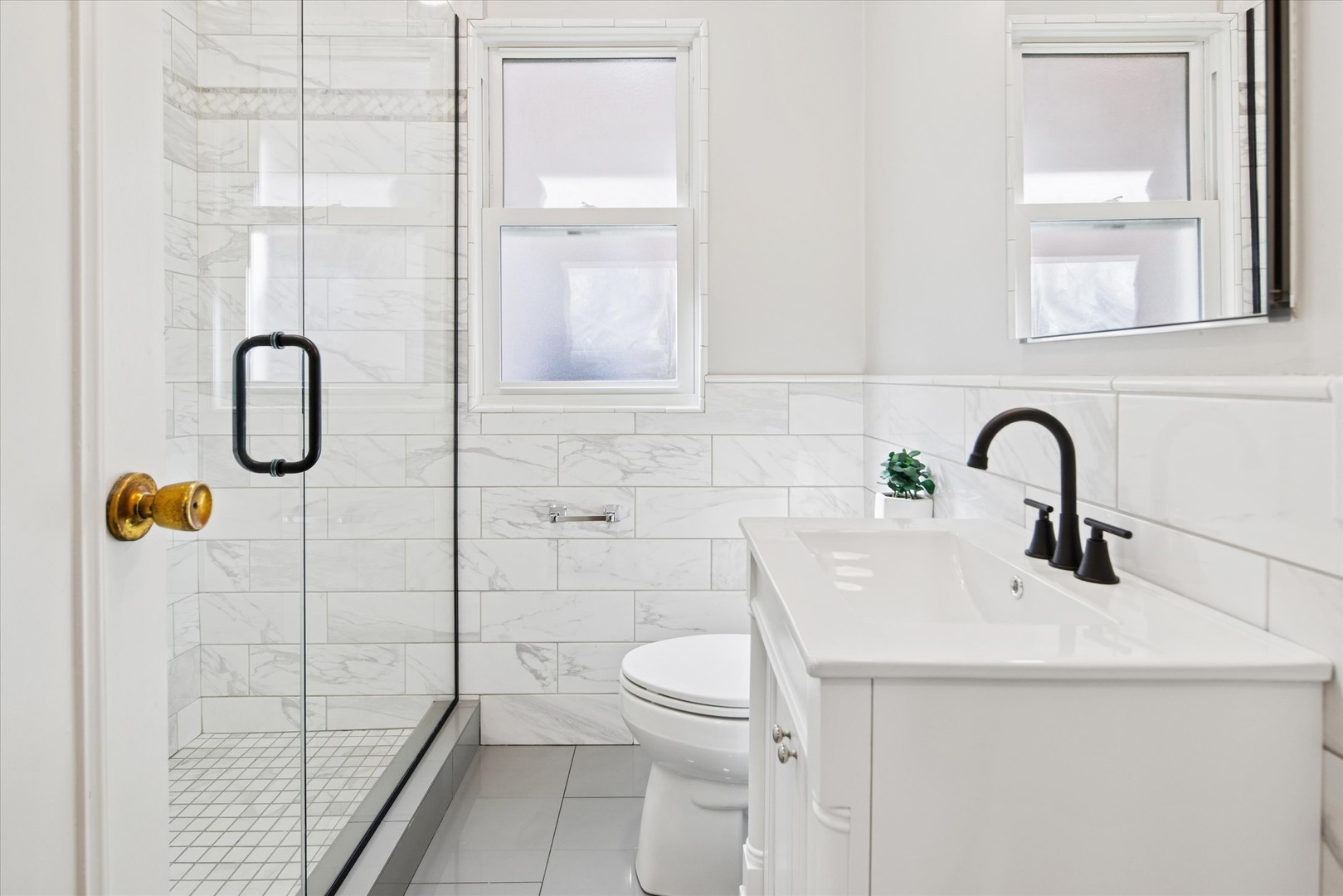 5604 North Mango Avenue Chicago, IL 60646 - Photo 11 of 20 a bathroom with a sink a toilet and a shower