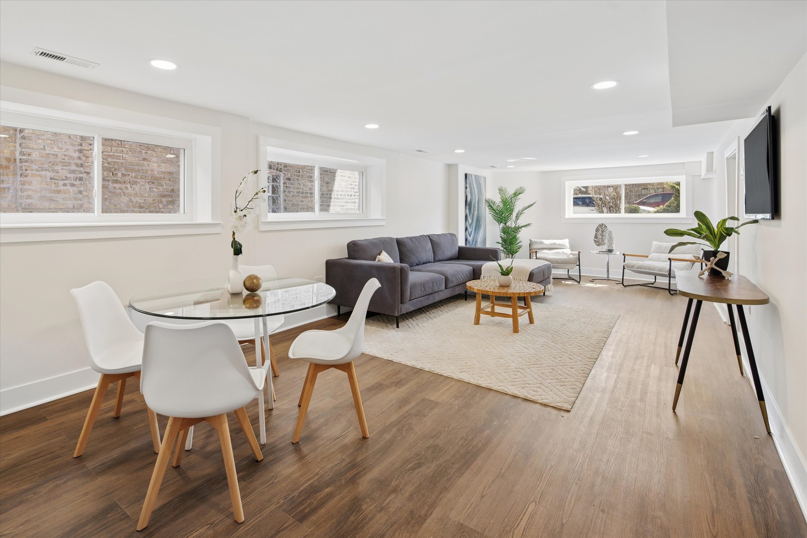 5604 North Mango Avenue Chicago, IL 60646 - Photo 14 of 20 a living room with furniture a table and wooden floor