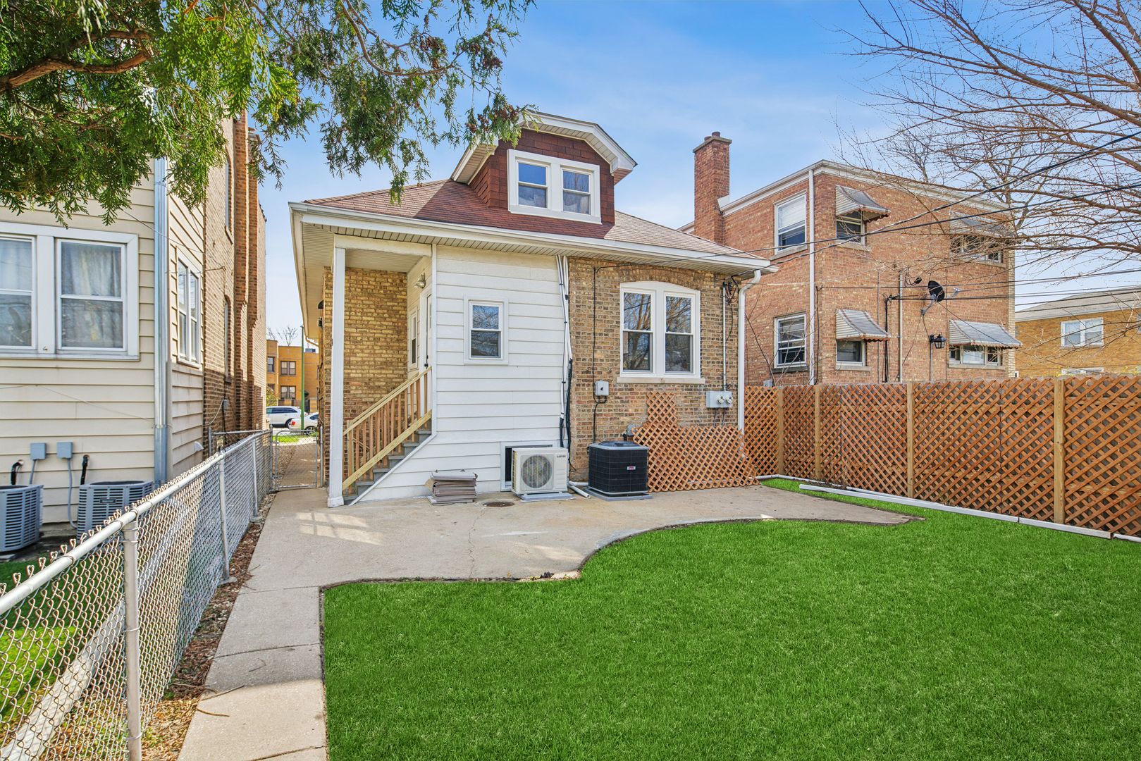 5604 North Mango Avenue Chicago, IL 60646 - Photo 19 of 20 a view of a house with a yard and sitting area