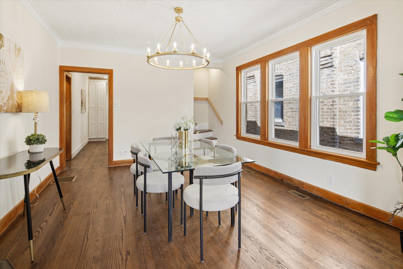 5604 North Mango Avenue Chicago, IL 60646 - Photo 6 of 20 a view of a dining room with furniture wooden floor and chandelier