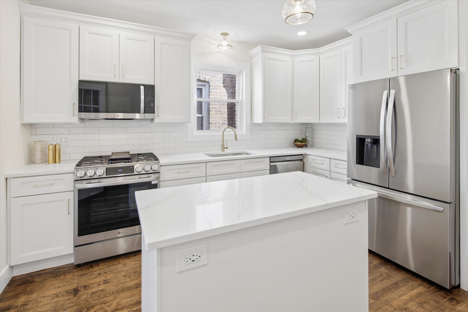 5604 North Mango Avenue Chicago, IL 60646 - Photo 7 of 20 a kitchen with stainless steel appliances a refrigerator stove and microwave
