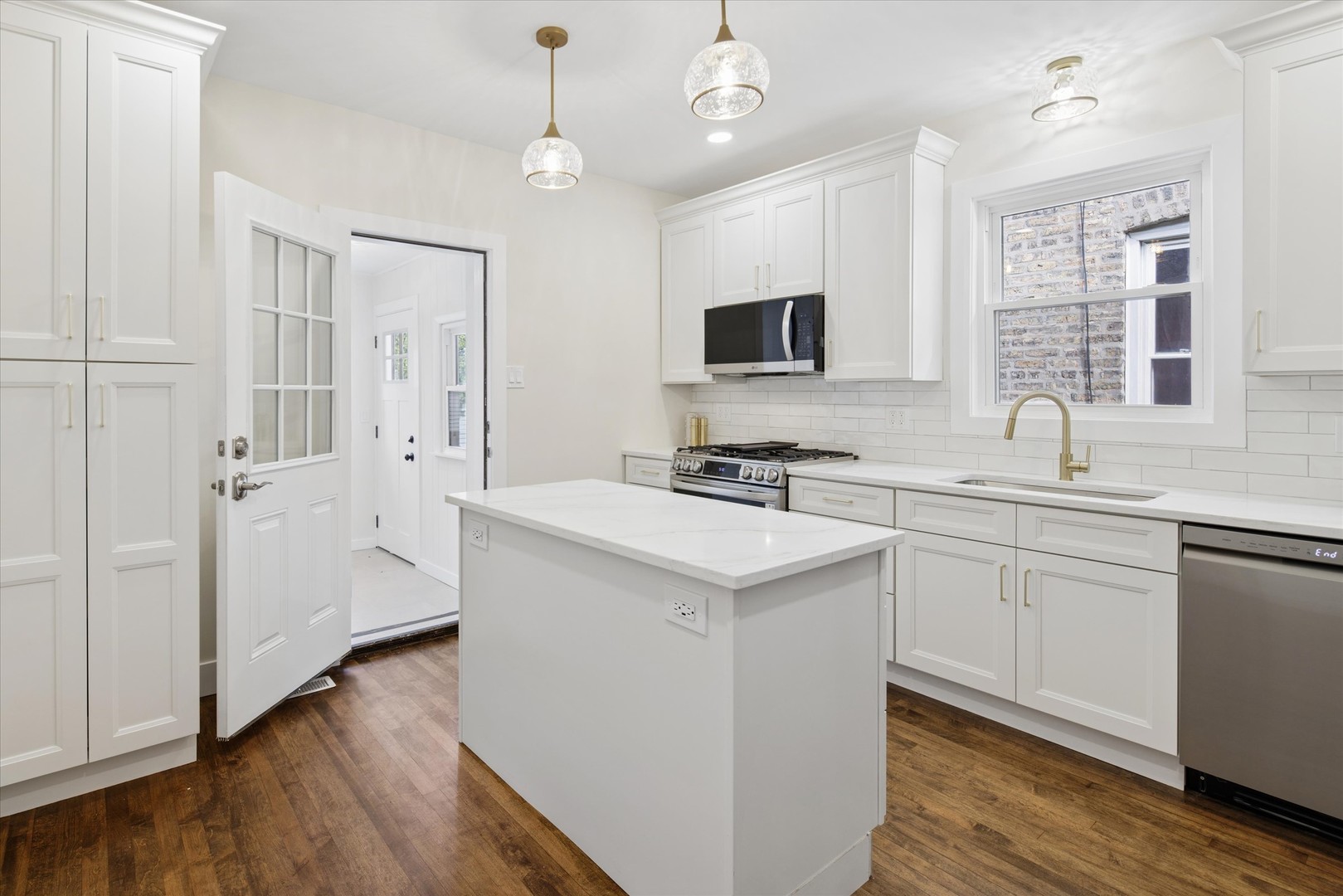 5604 North Mango Avenue Chicago, IL 60646 - Photo 8 of 20 a kitchen with a sink stove and refrigerator