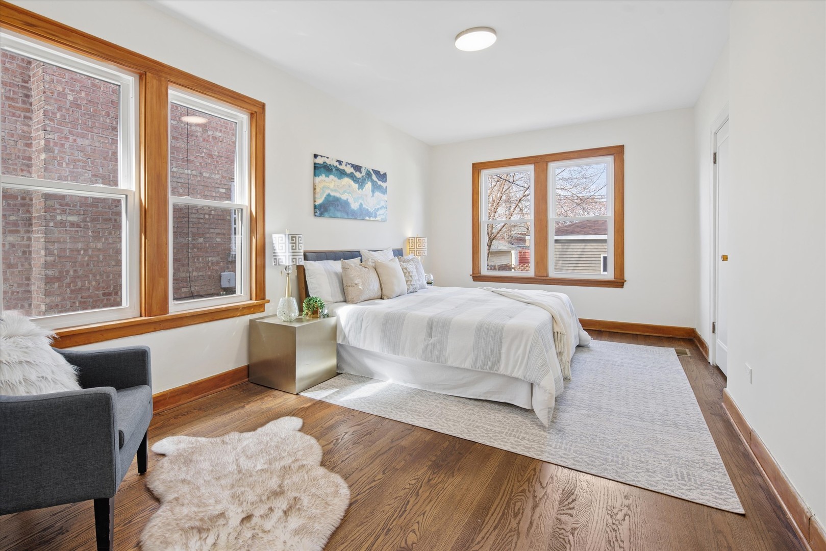 5604 North Mango Avenue Chicago, IL 60646 - Photo 9 of 20 a bedroom with a large bed and wooden floor
