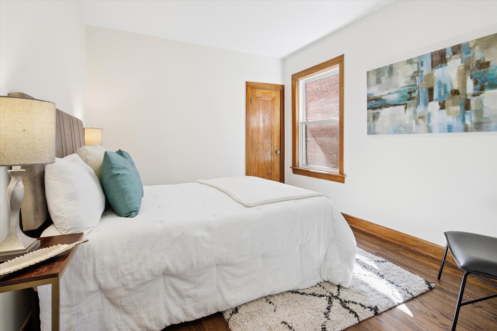 5604 North Mango Avenue Chicago, IL 60646 - Photo 10 of 20 a bedroom with a bed and wooden floor