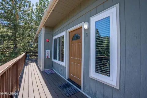 a view of balcony with wooden floor and fence
