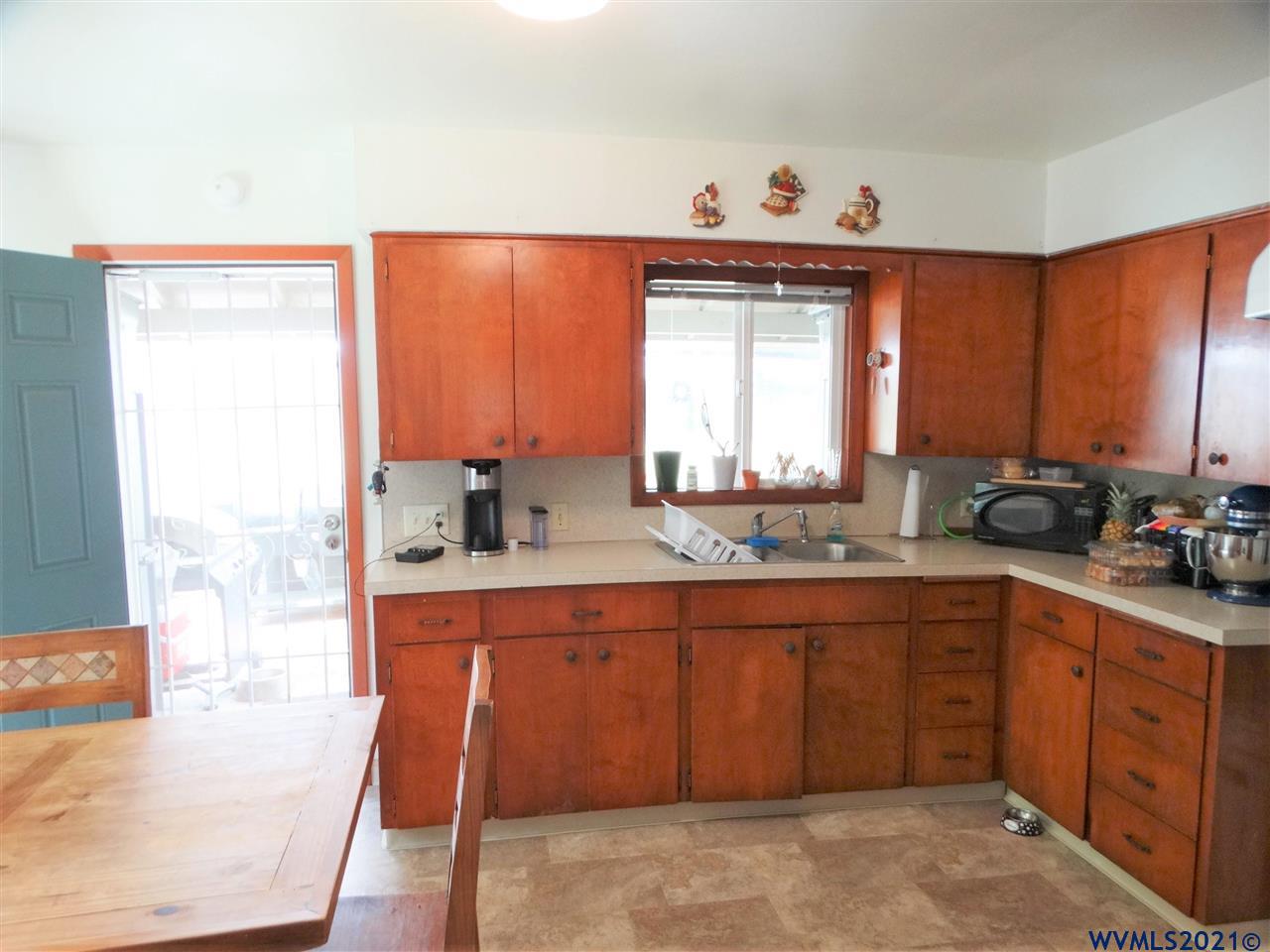 12615 Fishback Road Monmouth, OR 97361 - Photo 6 of 21 a kitchen with stainless steel appliances granite countertop a sink and cabinets