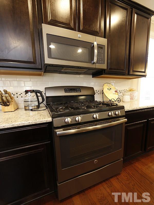 1145 Chapanoke Road Raleigh, NC 27603 - Photo 11 of 25 A close up of the appliances and the tile backsplash detail.