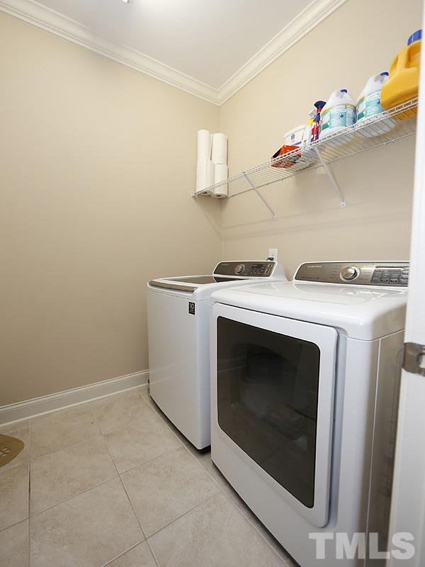 1145 Chapanoke Road Raleigh, NC 27603 - Photo 13 of 25 The laundry room with tile floor and shelf for storage is located near the back garage door-very convenient!