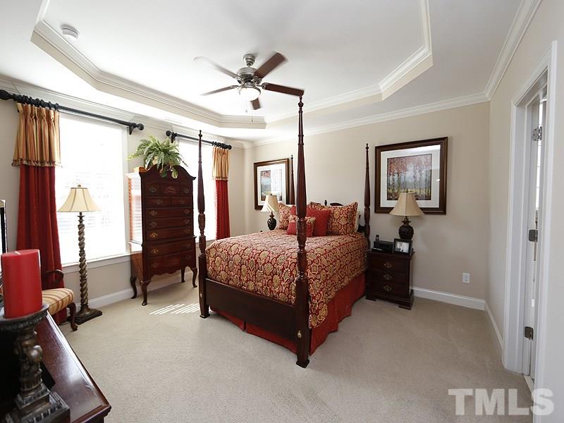 1145 Chapanoke Road Raleigh, NC 27603 - Photo 15 of 25 The first floor master suite with tray ceiling and fan, is nestled away in the front of the home.